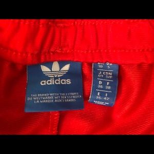 Red adidas three stripe track shorts